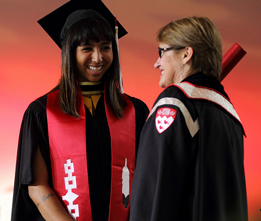Indigenous graduate receiving her diploma from McGill Principal, Suzanne Fortier